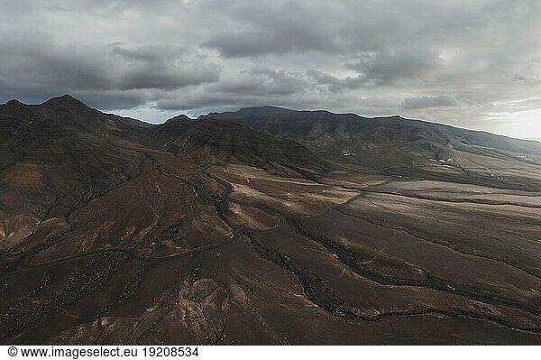 Volcanic landscape with cloudy sky at Fuerteventura