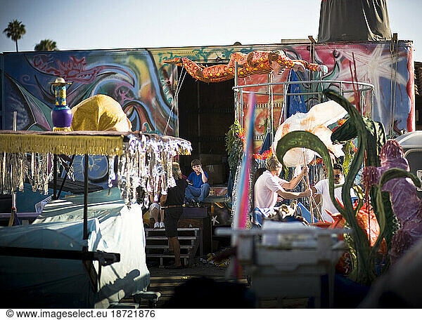 Volunteers at the workshop for a parade in Santa Barbara. The parade features extravagant floats and costumes.
