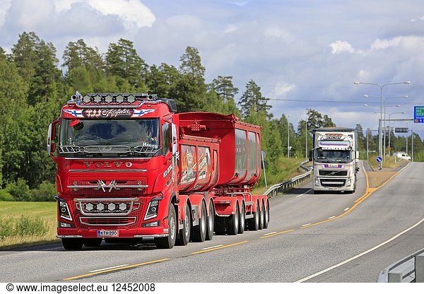 Volvo FH truck Red Devil of TJJ Kuljetus Oy for gravel haul on the road in summer with another Volvo transporter. Kaarina  Finland - June 29  2018.
