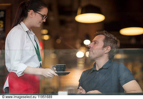 Waitress serving customer coffee