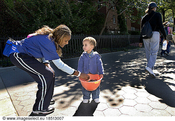 Walker accepts candy from a bystander during the Avon Walk for Breast Cancer in New York City.