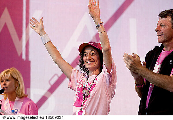 Walker and walk organizer Karen Borkowsky raises her hands during the closing ceremonies of the Avon Walk for Breast Cancer in N