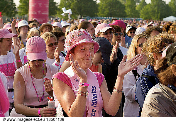 Walker applauds at opening ceremonies at a breast cancer walk.