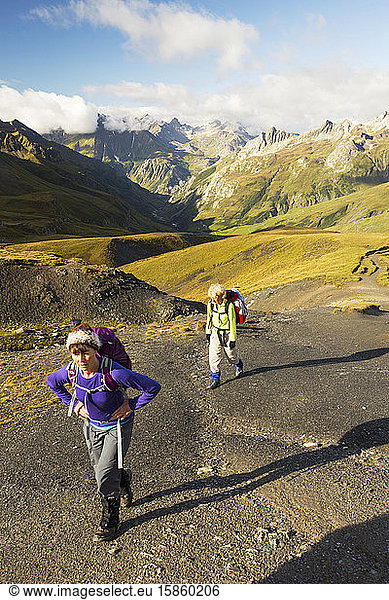 Walkers on the Tour de Mont Blanc ascending the Col de la Seigne