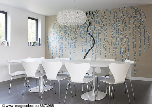 Wall art and chandelier in modern dining room
