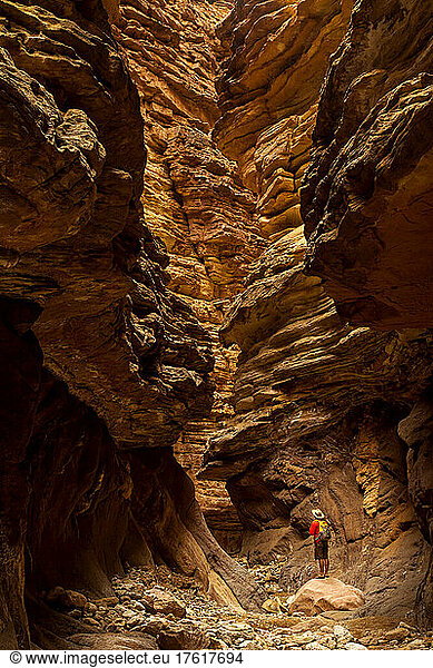 Wanderer in einem Slot Canyon  der Sandsteinschichten und Erosion beobachtet.