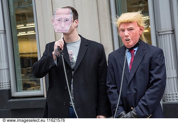Washington  DC USA - 20 January 2017 - Protesters at the inauguration of President Donald Trump. A man carrying a Vladimir Putin mask leads around a Donald Trump character on a chain.