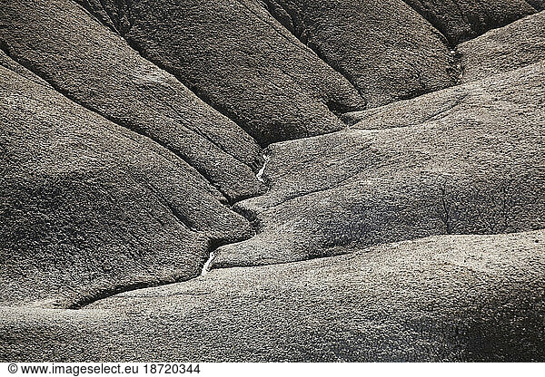Water erosion carves clear hydrological pathways into the mancos shale badlands near Factory Butte  Utah.