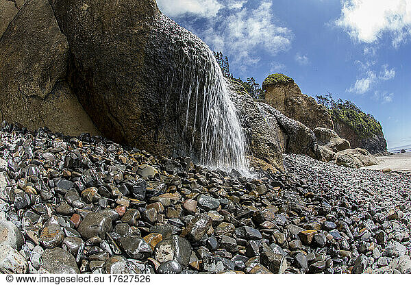 Water falling on rocky beach at Hug Point state park.