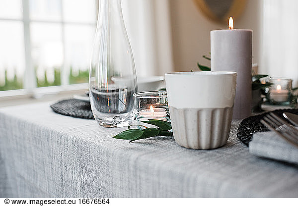 water glass and candle on a romantic dinner table for two