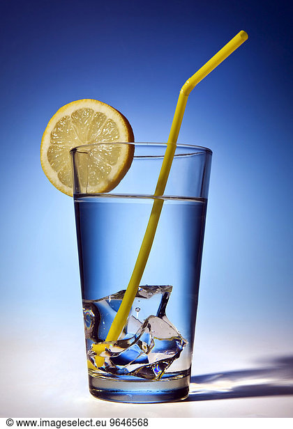 Water glass with ice cubes and lemon slice