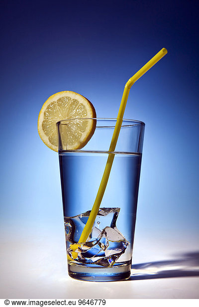 Water glass with ice cubes and lemon slice