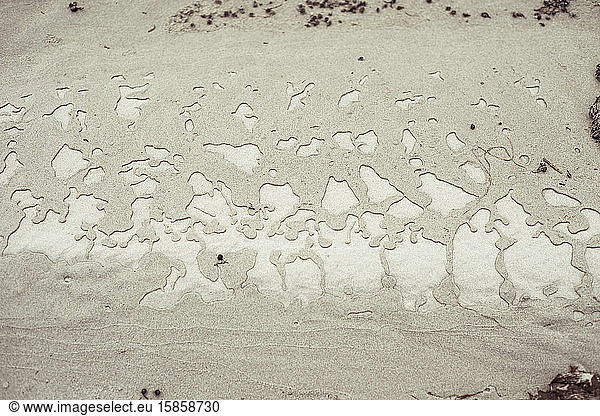 water patterns on beach sand on remote beach in western australia