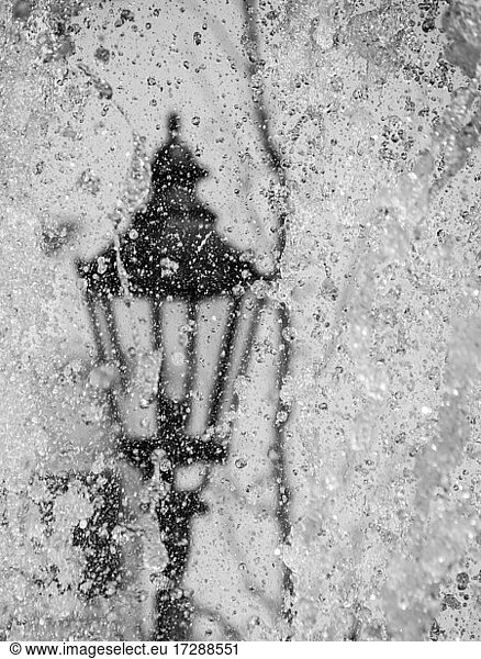 Water splashed on street lamp