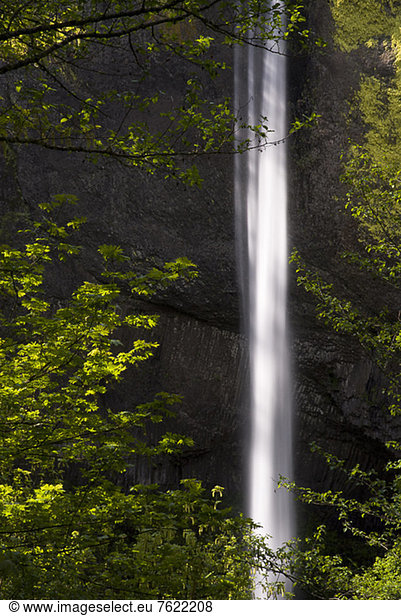 Waterfall in green rural landscape