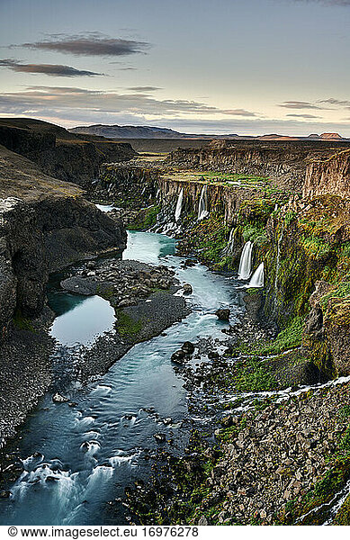 Waterfalls and river in canyon in evening