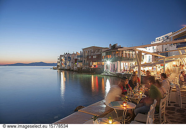 Waterfront restaurants at night in Mykonos  Greece