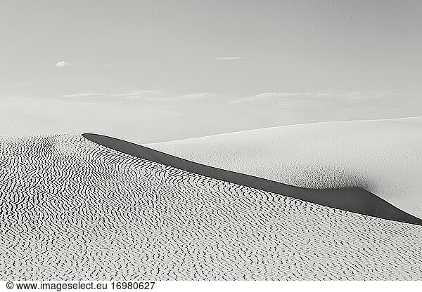 Wave of sand in light and shadow in black and white  White Sands NP.