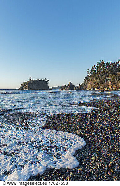 Waves breaking on the pebbles of Ruby Beach at dawn.