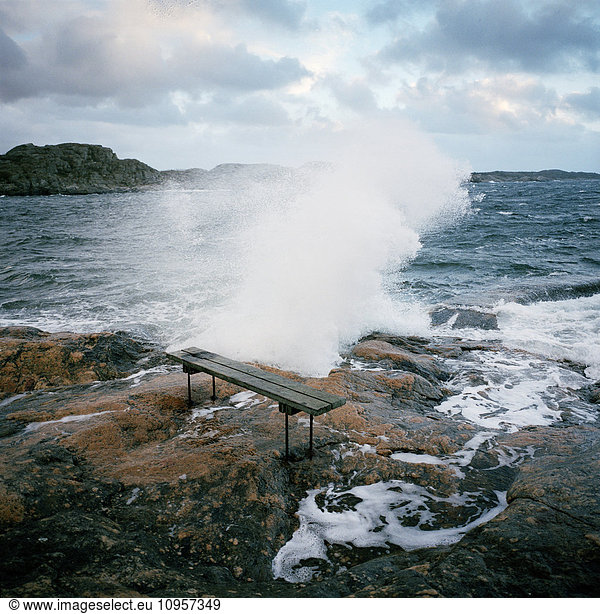 Waves running high against a rock  Sweden.