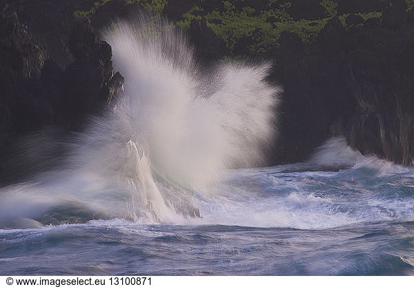 Waves splashing on rocks at Maui island