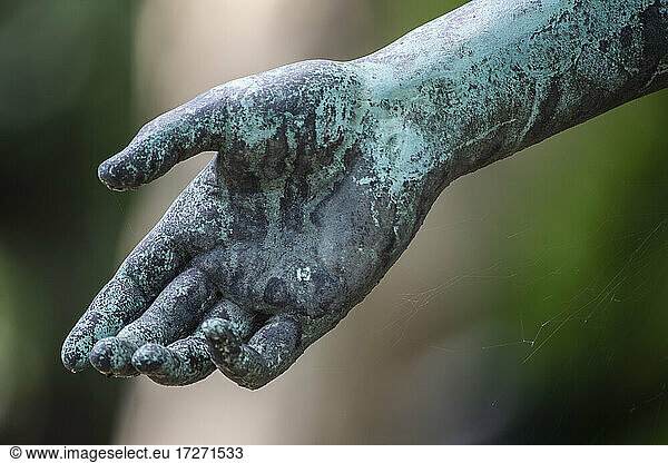 Weathered arm of bronze statue