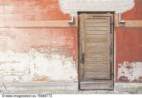Weathered wall and wooden entrance door