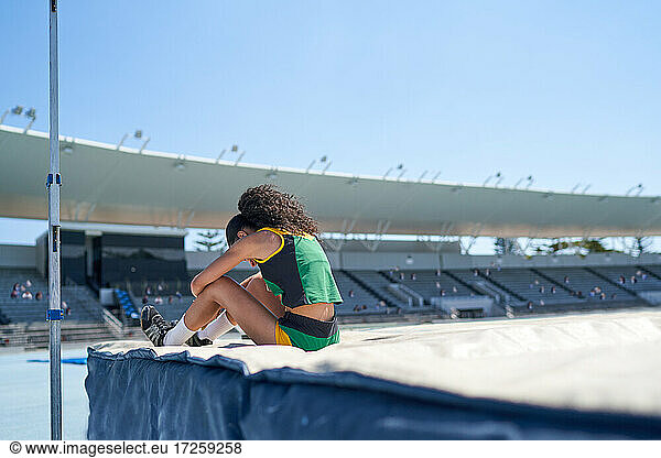Weibliche Leichtathletik-Hochspringerin im sonnigen Stadion