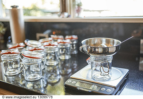 Weight scale by empty mason jars at kitchen counter