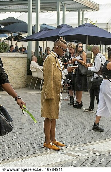 Well-dressed African man with camera at South African Fashion Week in Melrose Arch  Johannesburg  South Africa