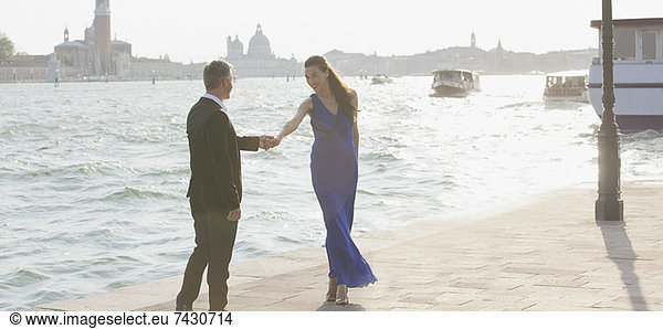 Well-dressed man and woman at waterfront in Venice