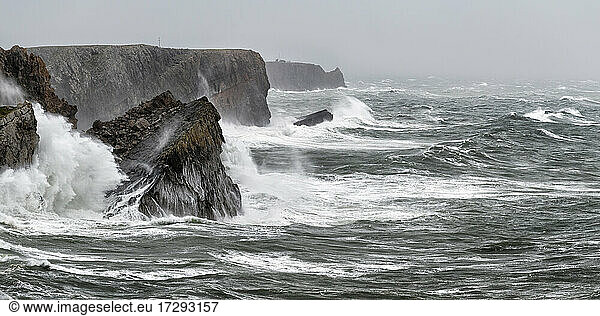 Wellen plätschern gegen steile Küstenklippen