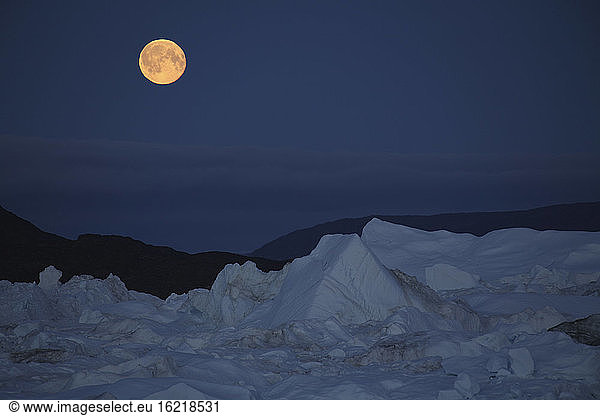 West Greenland  Ilulissat  Iceberg with full moon