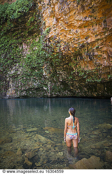 Western Australia  Young woman in swim suit at Emma Gorge waterfall