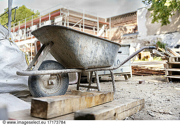 Wheelbarrow with construction material at construction site