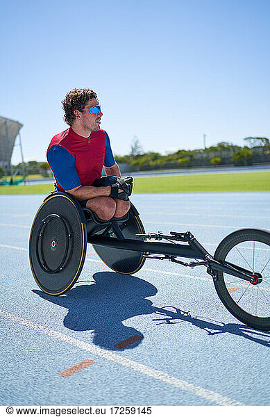 Wheelchair athlete on sunny sports track
