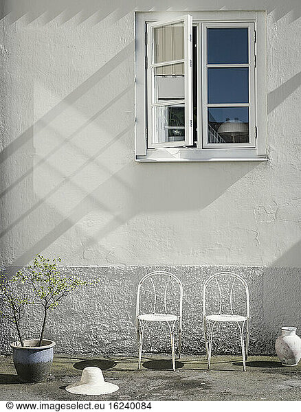 White chairs in front of house