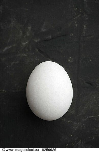 White egg on a black table.