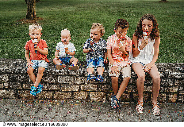 White family and kids eating ice cream together during holidays