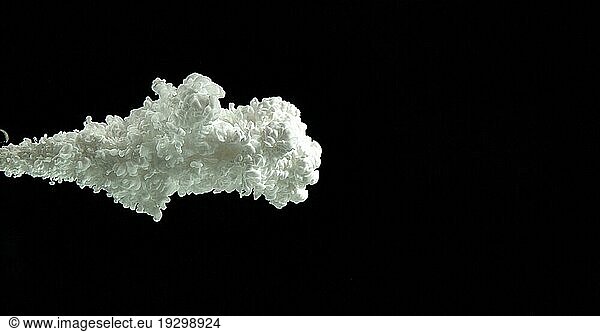 White Ink entering Water against Black Background