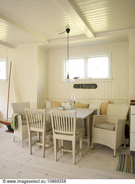 White panelled living room with dining table