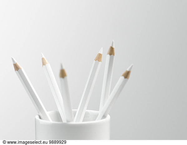White pencils in white cup still life