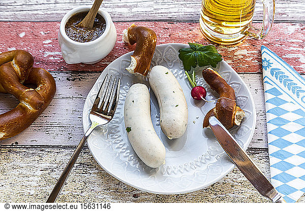 White sausage breakfast with pretzels  mustard and beer