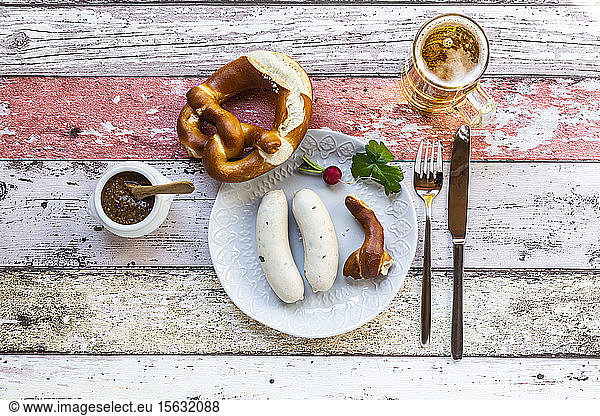 White sausage breakfast with pretzels  mustard and beer