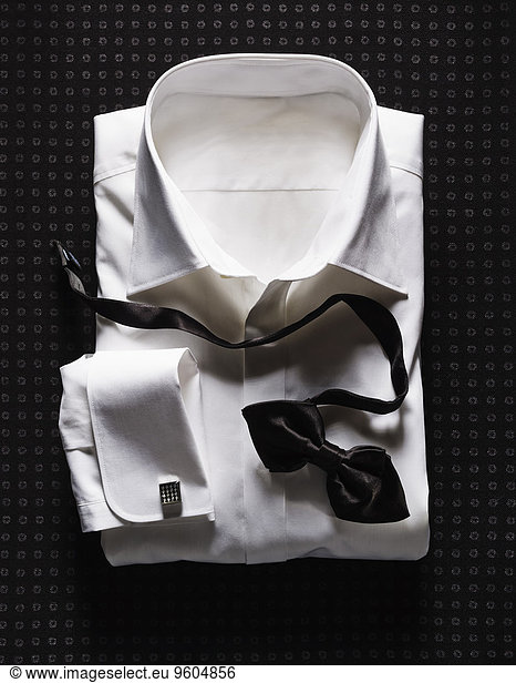 White Shirt with Double Cuffs and Black Bow Tie on Dotted Background