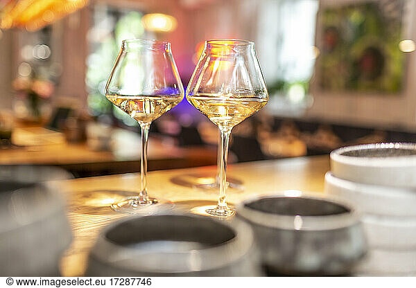 White wine in glass at table in bar