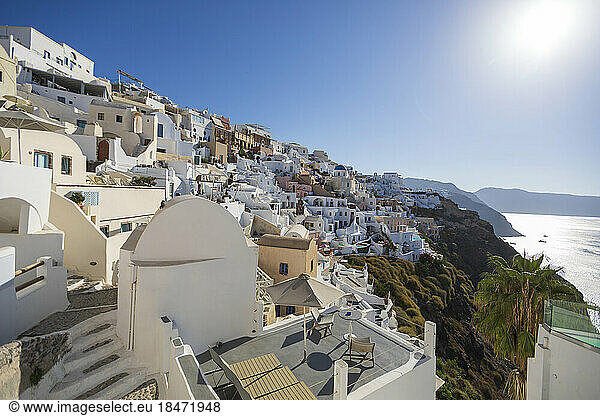 Whitewashed houses on hill under sky