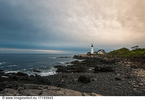 Wide angle view of Portland Head Lighthouse during sunrise.