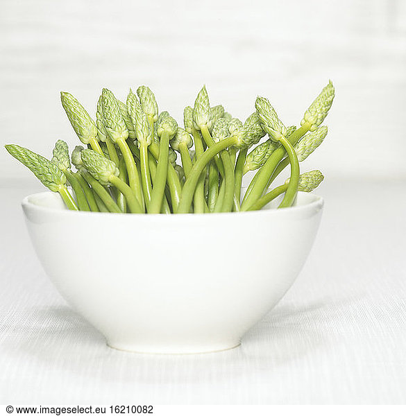 Wild asparagus in bowl  close-up