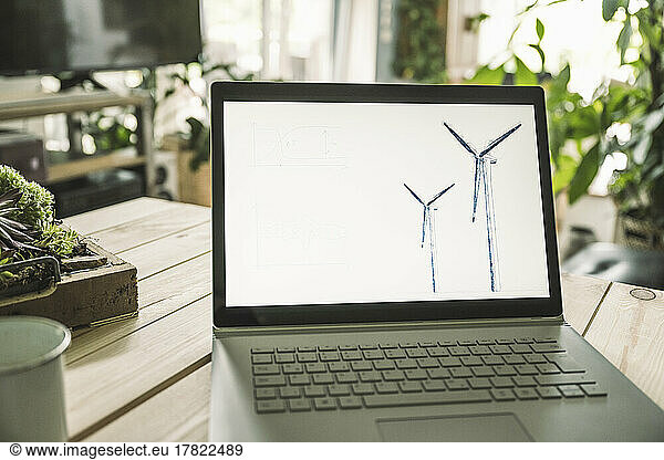 Wind turbine design on screen of laptop at home office